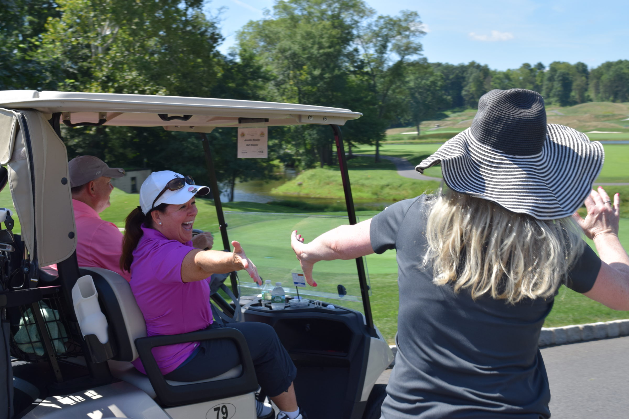 golfer on cart getting high-five