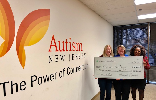 Autism New Jersey Executive Director Dr. Suzanne Buchanan accepts a donation from Edith Legg (middle) and Sandy Broughton (r) of Investors Foundation.