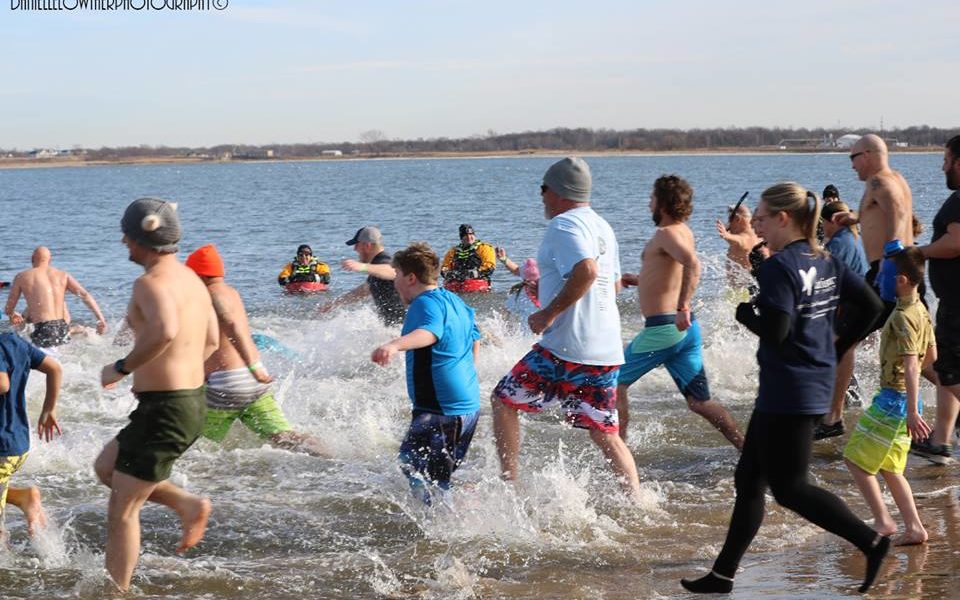 A group of supporters run into the ocean at the 1st Annual Polar Bear Plunge