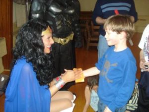 Valerie Cullari dresses as Wonder Woman with young boy